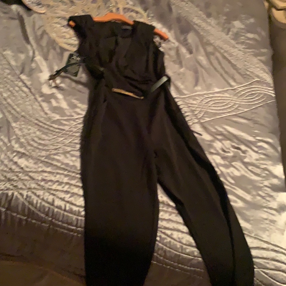 Beautiful jumpsuit and black size medium brand new with belt